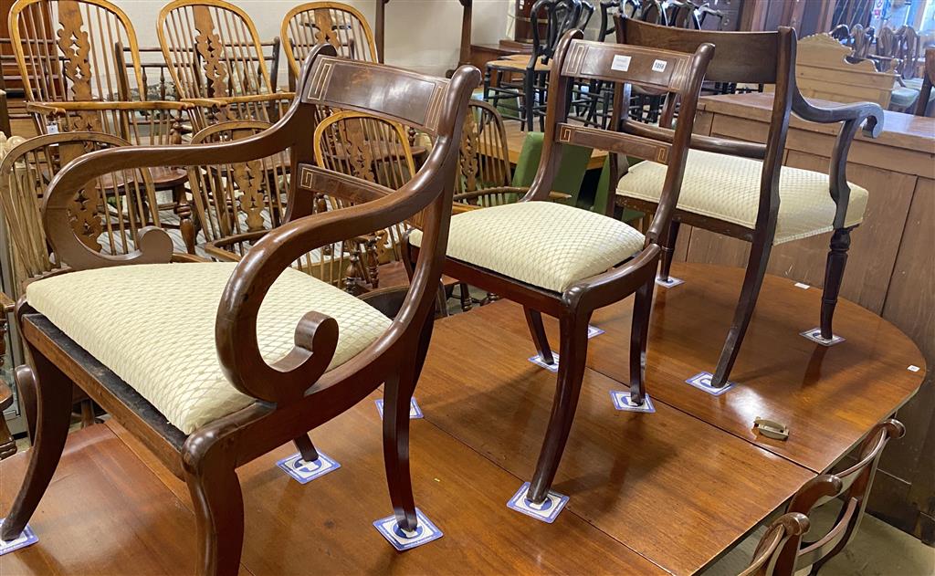 A set of eight Regency mahogany brass inlaid dining chairs, on sabre legs and a similar elbow chair